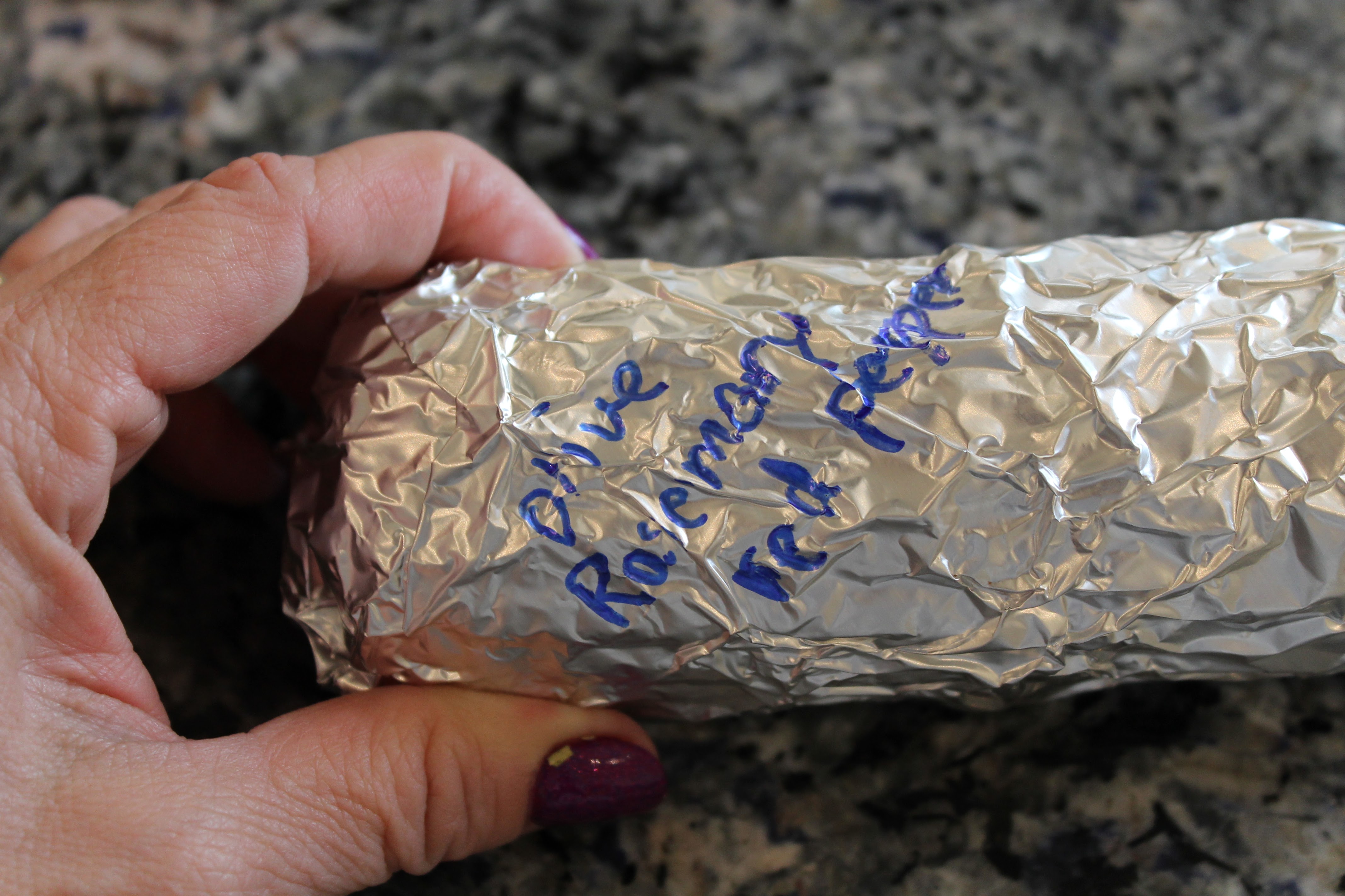 Wrapped corn labeled with the seasonings - rosemary and red pepper.