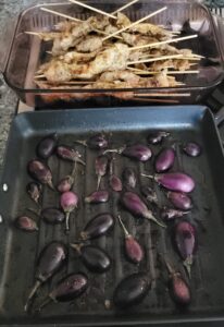 The halved mini eggplants absorb the flavor from the "just grilled" Sumac Chicken.