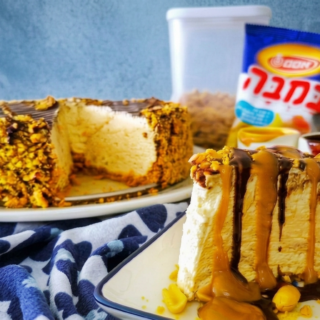 Two cakes on plates: a nut-crusted cake in the background and a caramel-drizzled cheesecake slice in the foreground.